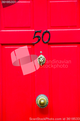 Image of red handle in   rusty  brass nail and light