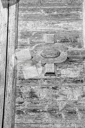 Image of grain texture of a brown antique wooden old door in italy   euro
