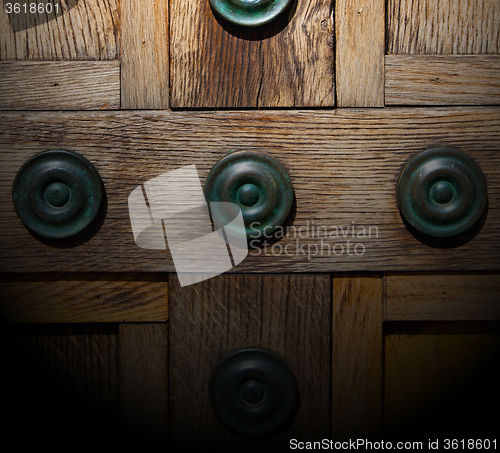 Image of in london antique brown door  rusty  brass nail and light