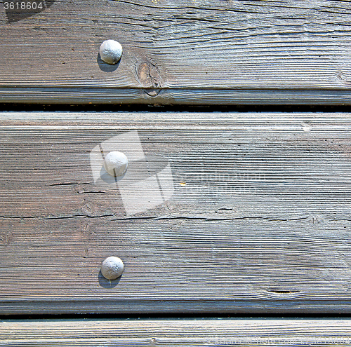 Image of abstract texture of a brown antique wooden old door in italy   e