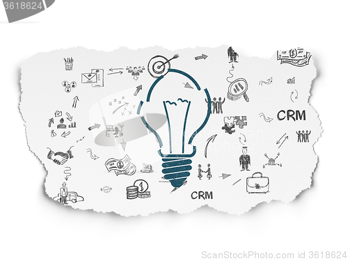 Image of Finance concept: Light Bulb on Torn Paper background