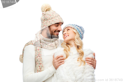 Image of smiling couple in winter clothes hugging