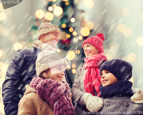 Image of happy family in winter clothes outdoors