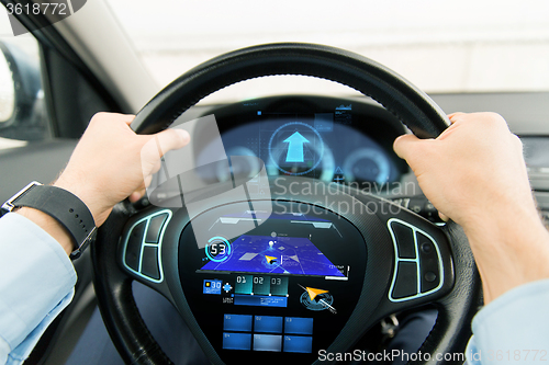 Image of close up of man driving car with gps navigator