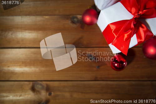 Image of close up of gift boxes and red christmas balls