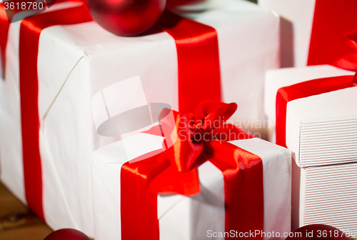 Image of close up of gift boxes and red christmas balls