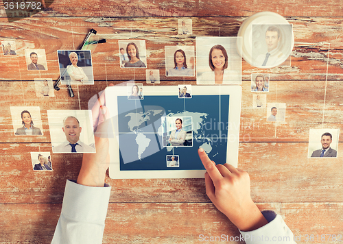 Image of close up of hands with tablet pc and network