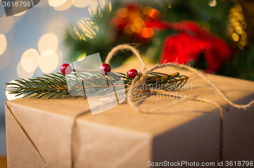 Image of close up of christmas gift with fir brunch