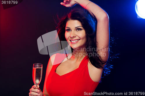 Image of beautiful woman with champagne glass at nightclub