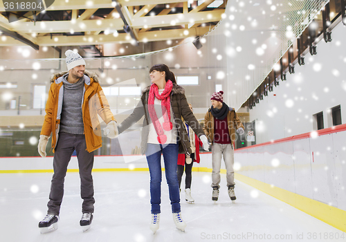 Image of happy friends on skating rink