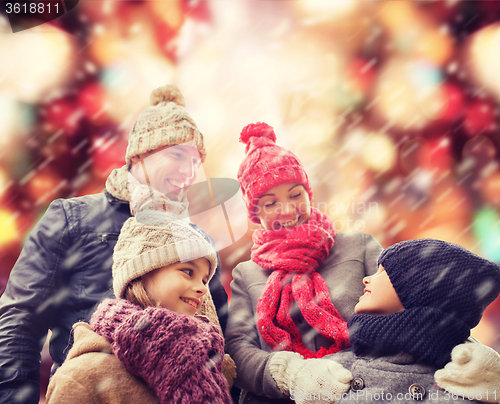 Image of happy family in winter clothes outdoors