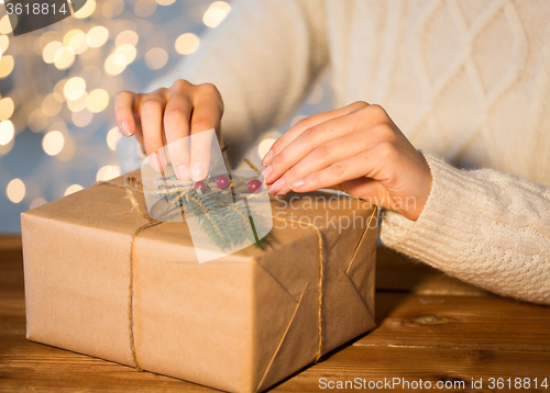 Image of close up of woman with christmas gift or parcel