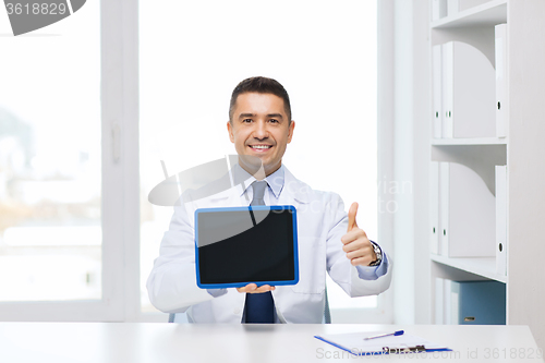 Image of smiling doctor showing tablet pc and thumbs up