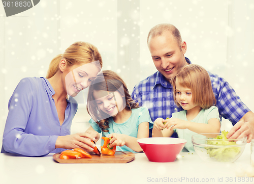 Image of happy family with two kids making dinner at home