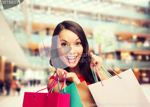 Image of smiling woman with colorful shopping bags