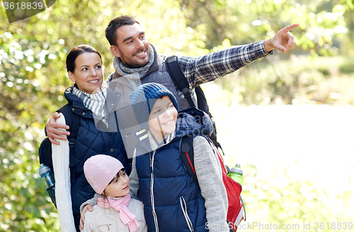 Image of happy family with backpacks hiking