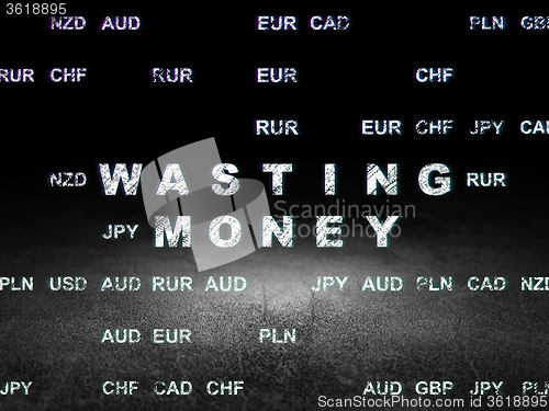 Image of Money concept: Wasting Money in grunge dark room