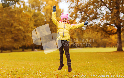 Image of happy little girl jumping outdoors