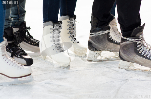 Image of close up of legs in skates on skating rink