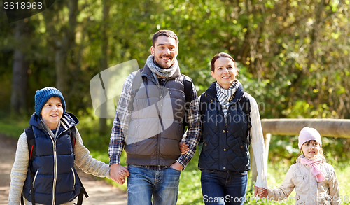 Image of happy family with backpacks hiking