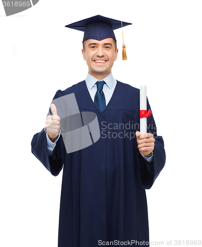 Image of smiling adult student in mortarboard with diploma