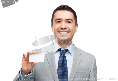 Image of smiling businessman in suit showing visiting card
