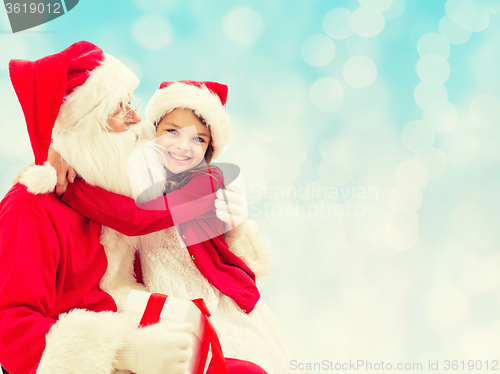 Image of smiling little girl with santa claus