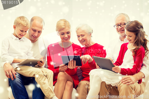 Image of smiling family with tablet pc computers at home