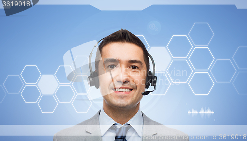 Image of smiling businessman in headset over virtual screen