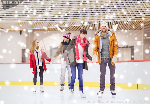 Image of happy friends on skating rink