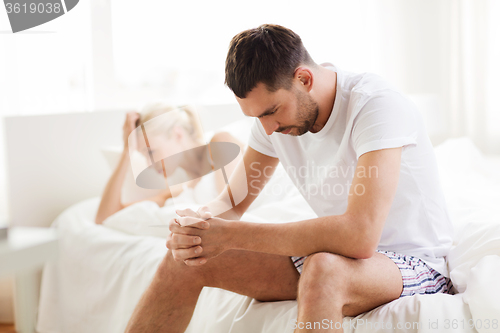 Image of unhappy couple having problems at bedroom