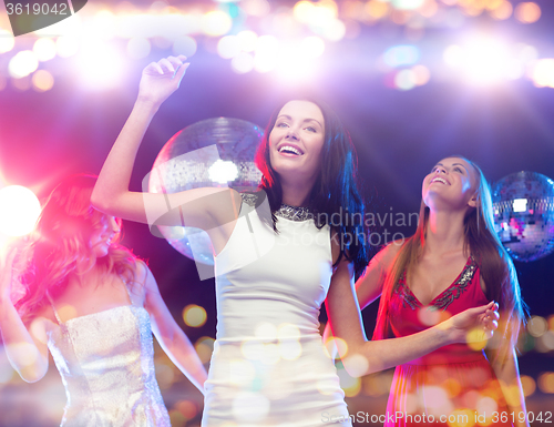 Image of happy women dancing at night club