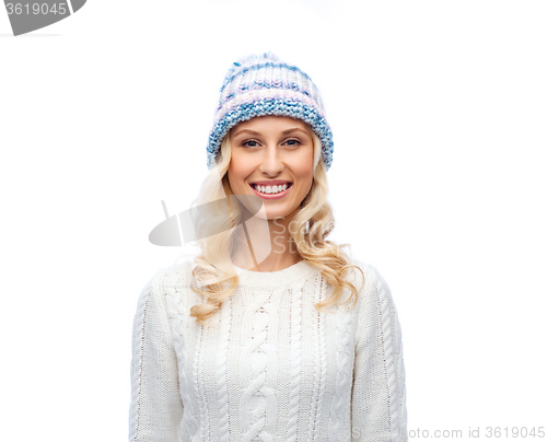 Image of smiling young woman in winter hat and sweater