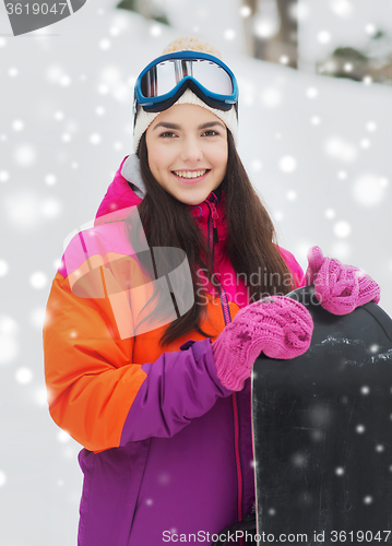 Image of happy young woman with snowboard outdoors