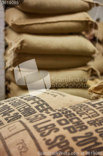 Image of stack of burlap sacks with coffee beans