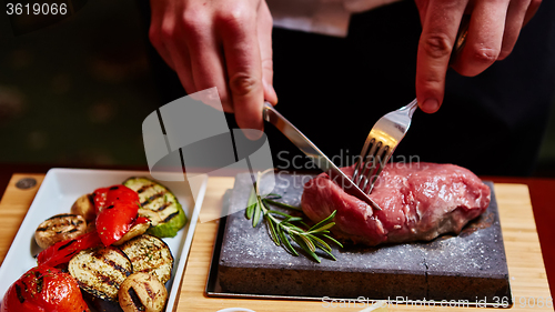 Image of meat grilled on astone with vegetables