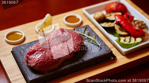 Image of meat grilled on astone with vegetables