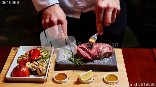Image of meat grilled on astone with vegetables