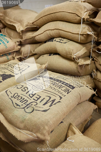 Image of stack of burlap sacks with coffee beans