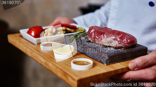 Image of meat grilled on astone with vegetables