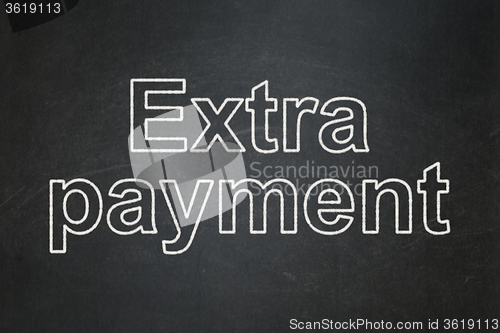 Image of Currency concept: Extra Payment on chalkboard background