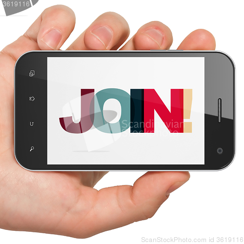 Image of Business concept: Hand Holding Smartphone with Join! on  display