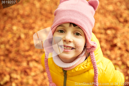 Image of happy little girl in autumn park