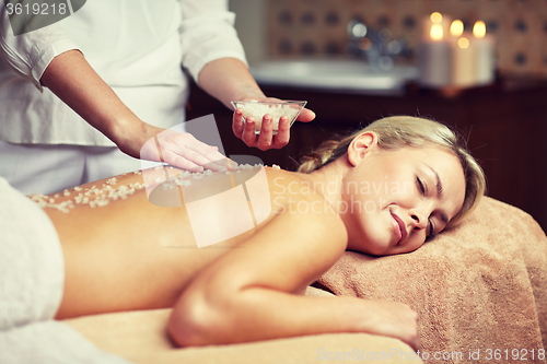 Image of close up of woman lying and having massage in spa