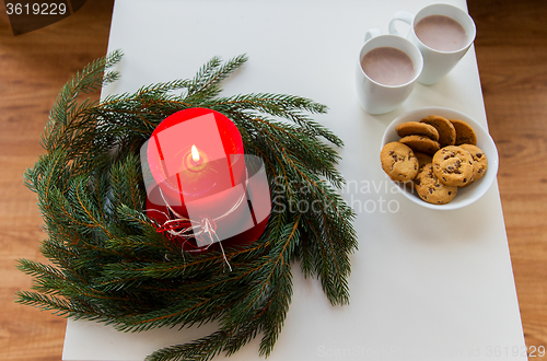 Image of close up of christmas wreath with candle on table