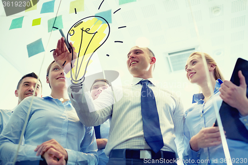 Image of smiling business people with marker and stickers