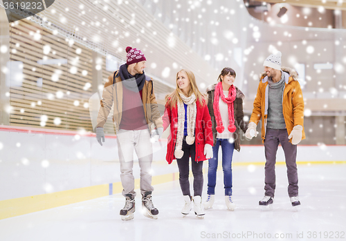 Image of happy friends on skating rink