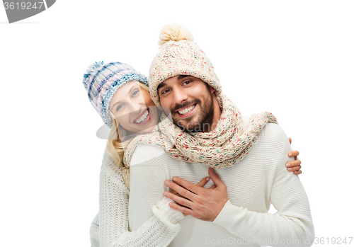 Image of smiling couple in winter clothes hugging