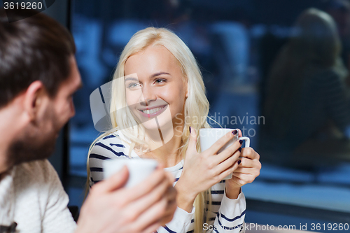 Image of happy couple meeting and drinking tea or coffee