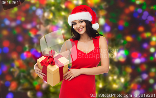 Image of beautiful sexy woman in santa hat with gift box